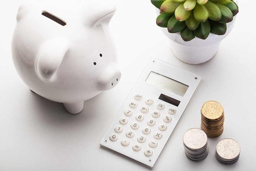 calculator, coins, piggy bank calculating home loans