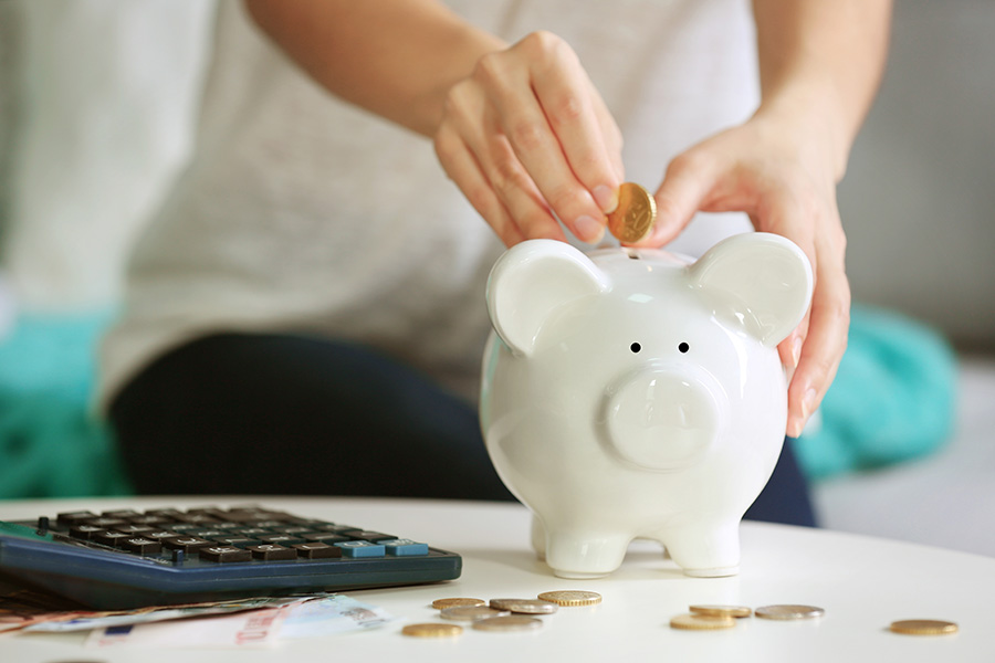 person using piggy bank for savings account