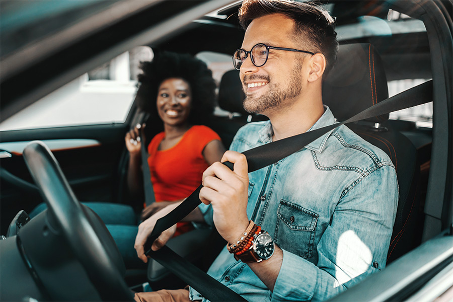 Couple enjoying new vehicle