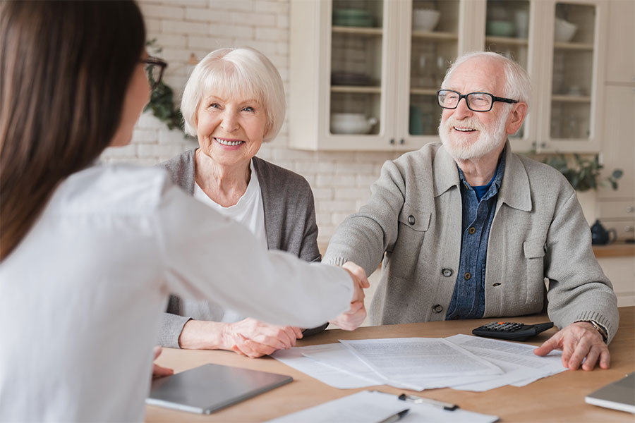 Vocal_Credit_Union_Personal_Loans Elderly couple discussing personal loans at home with banker